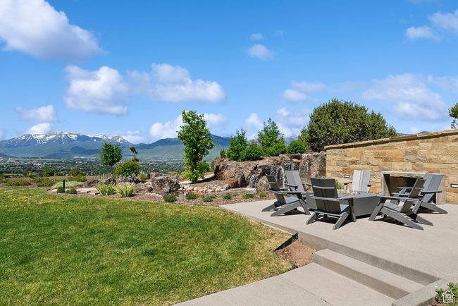 View of grassy yard featuring a mountain view and a patio area | Image 76