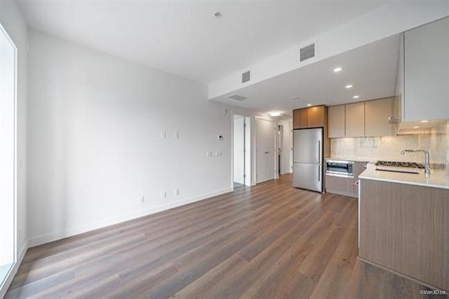 Kitchen with appliances with stainless steel finishes, dark wood finished floors, light countertops, recessed lighting, and backsplash | Image 8