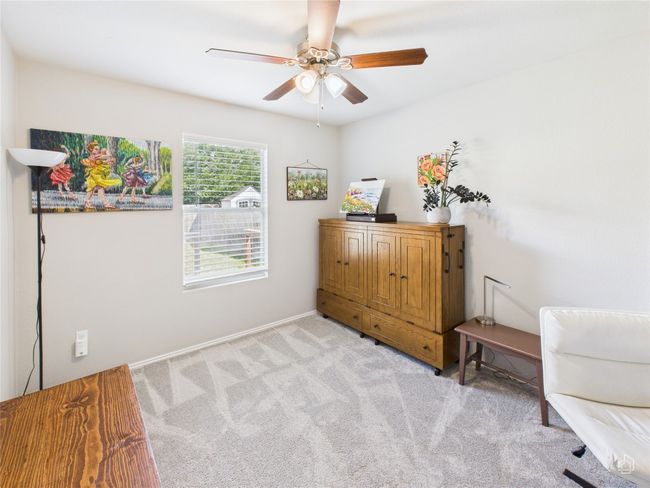 Living area with light colored carpet and a ceiling fan | Image 26