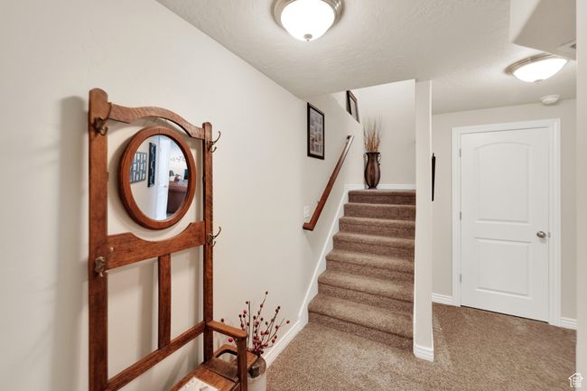 Stairway featuring carpet and a textured ceiling | Image 21