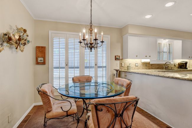 Dining room with healthy amount of natural light, a chandelier, baseboards, crown molding, and recessed lighting | Image 19