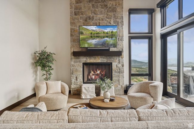 Living room with a fireplace and wood finished floors | Image 16