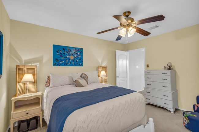 Bedroom featuring ceiling fan and light carpet | Image 31