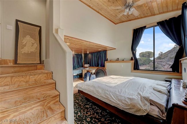 Bedroom with wood ceiling and ceiling fan | Image 40