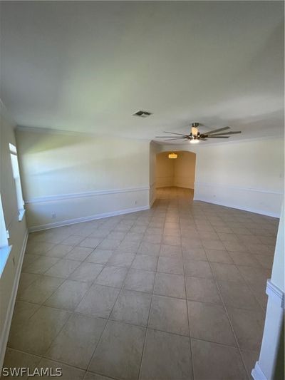 Empty room featuring tile flooring and ceiling fan | Image 2