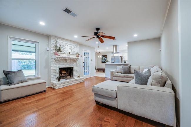 Beautiful family room with gorgeous wood floors, recessed lighting, ceiling fan, large window & door out to back yard | Image 7