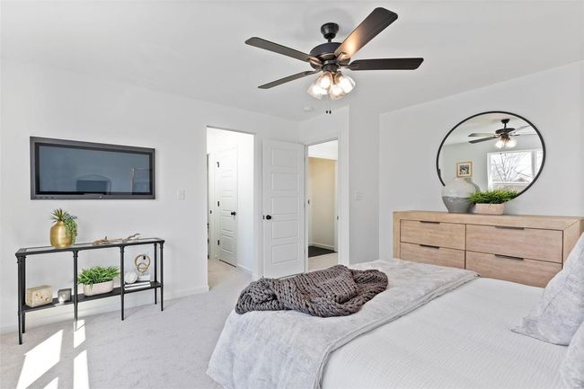 Bedroom featuring ceiling fan and light carpet | Image 21