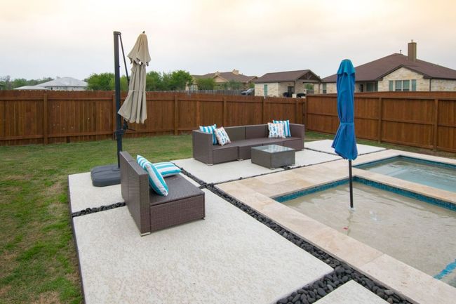 View of swimming pool with an outdoor hangout area, a fenced backyard, a lawn, and a patio area | Image 29