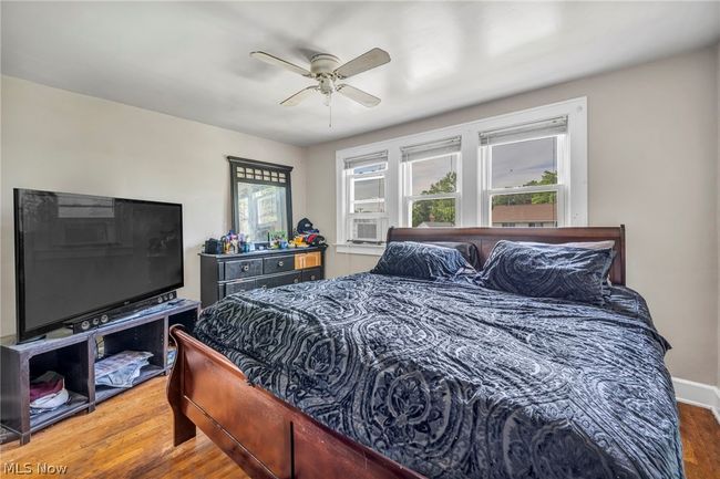 Bedroom with ceiling fan and hardwood / wood-style floors | Image 15