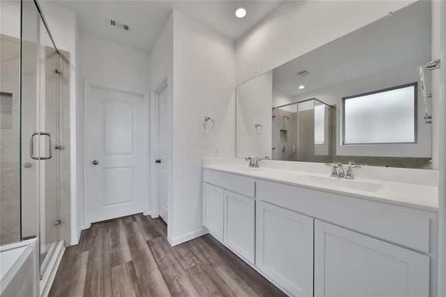 ...double sink vanity, separate toilet space, and walk-in closet. | Image 24