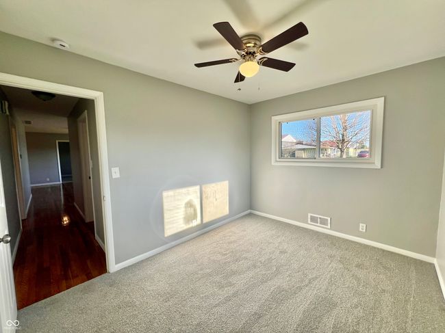 empty room with visible vents, baseboards, ceiling fan, and carpet floors | Image 20