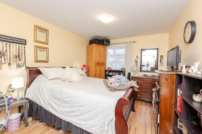 Bedroom with light wood finished floors | Image 26