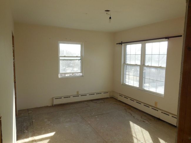 Spare room featuring a baseboard heating unit and a healthy amount of sunlight | Image 11