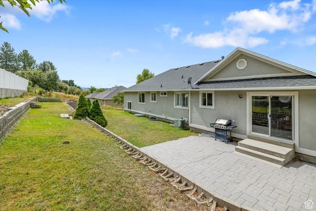 Rear view of property featuring a lawn and a patio | Image 42