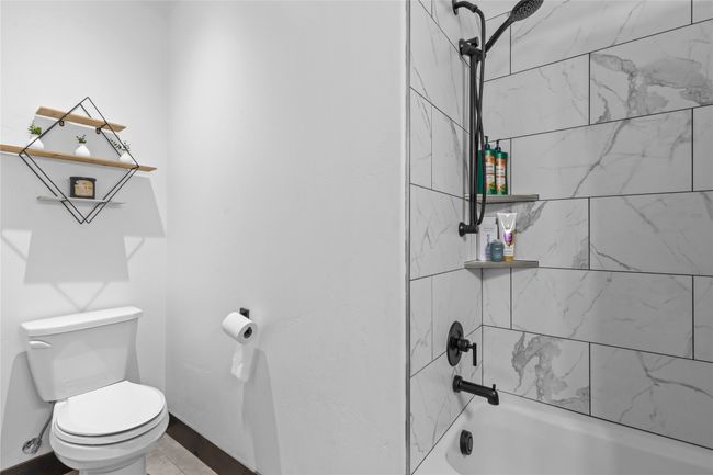 Bathroom featuring toilet and shower / bathtub combination | Image 17