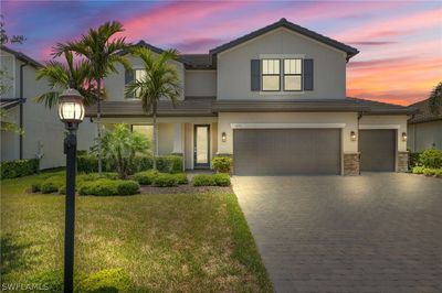 View of front of property featuring a garage and a lawn | Image 1