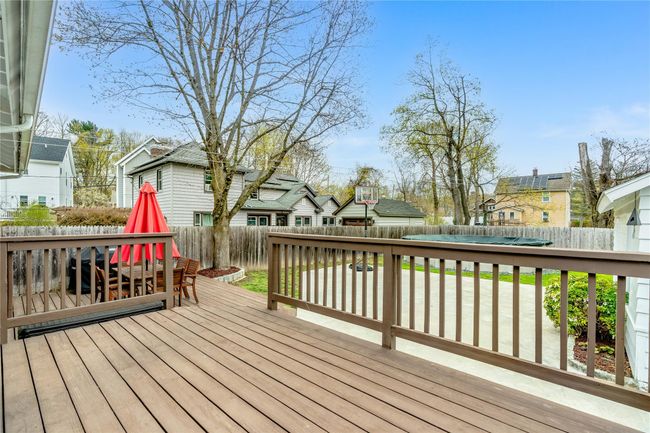 Deck with a fenced backyard and a residential view | Image 33