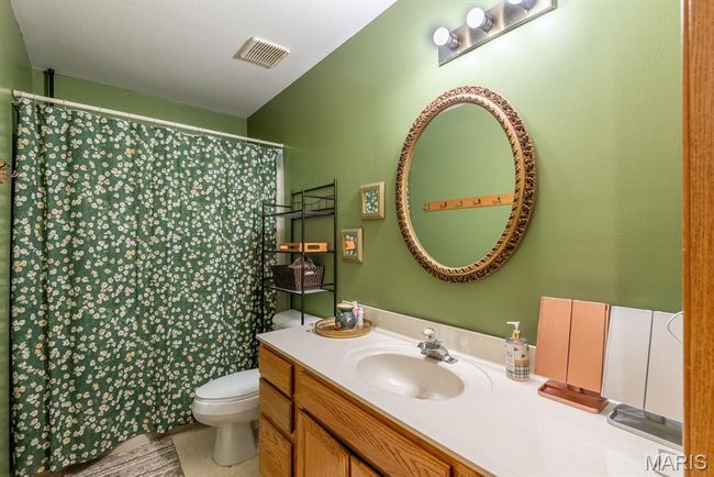 Full bath with vanity and curtained shower | Image 11