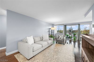 Living room with dark wood-type flooring | Image 2