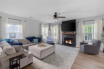 Great room featuring a wealth of natural light, LVP, and a custom fireplace. | Image 3