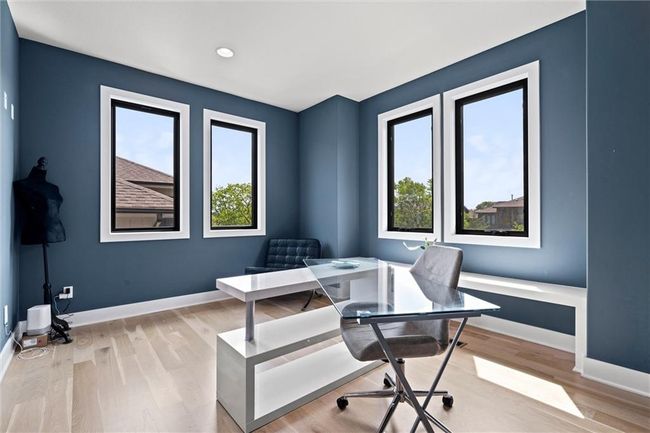 Office space featuring healthy amount of natural light, light wood finished floors, and recessed lighting | Image 9