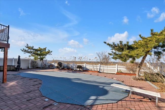 View of swimming pool featuring a patio area, a fenced backyard, and a fenced in pool | Image 16