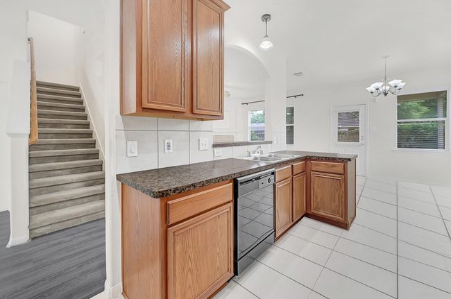 The kitchen has great views to the living room from the kitchen sink and breakfast table area. | Image 10