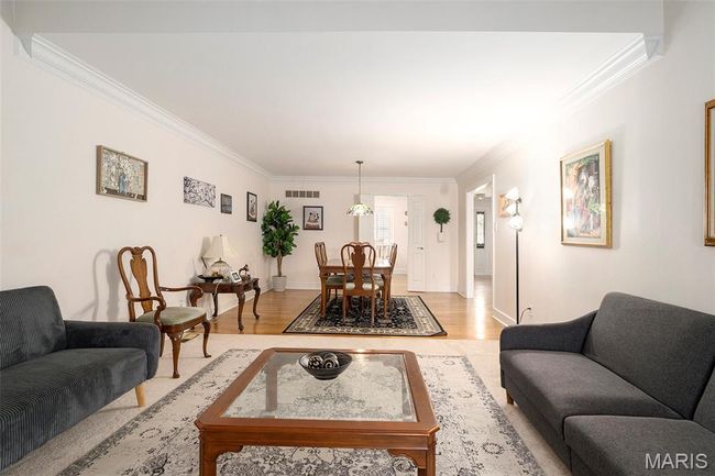 Living room with crown molding and light wood finished floors | Image 4