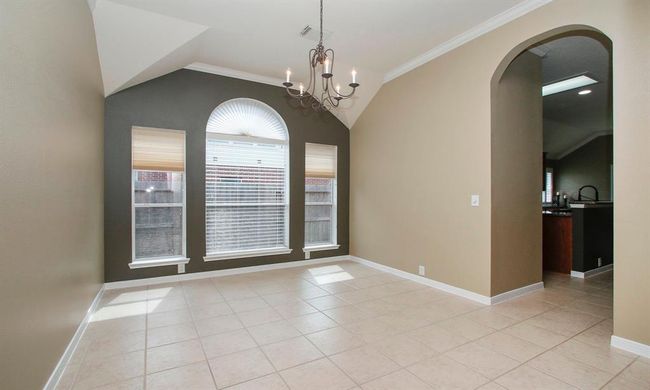 Enjoy dinner guests in this elegant formal dining RM situated just off the kitchen. | Image 10