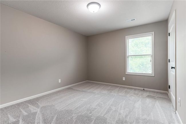 Unfurnished room featuring light colored carpet and a textured ceiling | Image 32