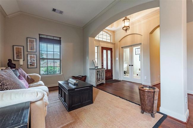 Front family room with wood flooring and high ceilings. | Image 14