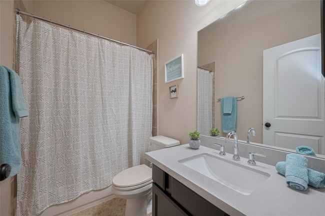 A full bath in the hallway adjoins the two front bedrooms, offering convenience and privacy for family or guests. | Image 6