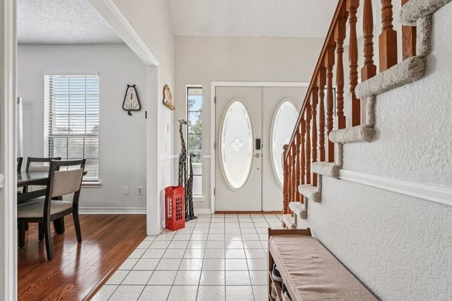 Foyer entrance with stairway, a textured ceiling, french doors, and light wood-type flooring | Image 4
