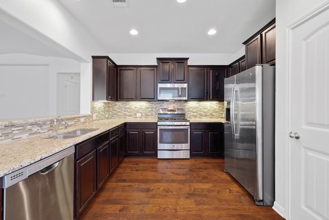 Large kitchen that opens up to the living and dining area | Image 12