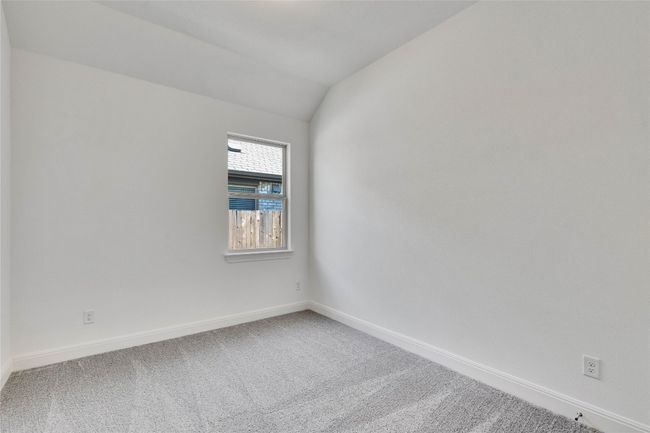 Carpeted empty room with baseboards and vaulted ceiling | Image 11