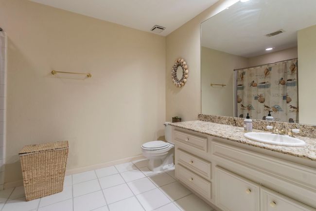 Full bathroom featuring toilet, vanity, tile patterned flooring, and baseboards | Image 21