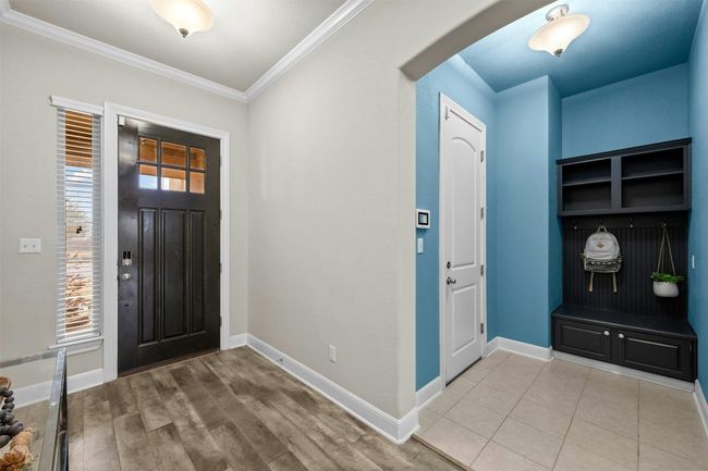 The convenient built-in mud area near the entry features custom storage cubbies and hooks, providing the perfect space to keep shoes, bags, and coats organized. | Image 26