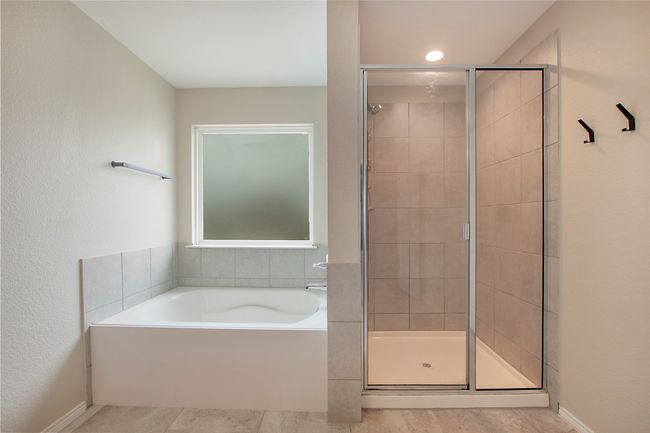 Bathroom featuring a shower stall, a bath, and tile patterned floors | Image 26