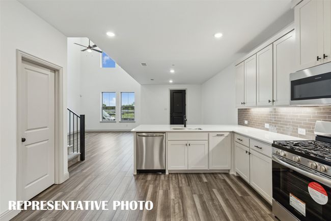 The kitchen peninsula with breakfast bar makes this the perfect place to grab a quick bite. REPRESENTATIVE PHOTO | Image 9