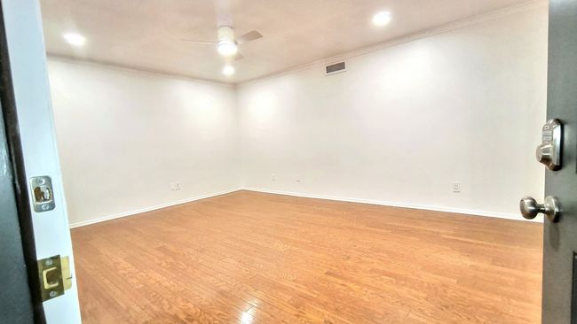 Unfurnished room with ornamental molding, ceiling fan, and light wood-type flooring | Image 4
