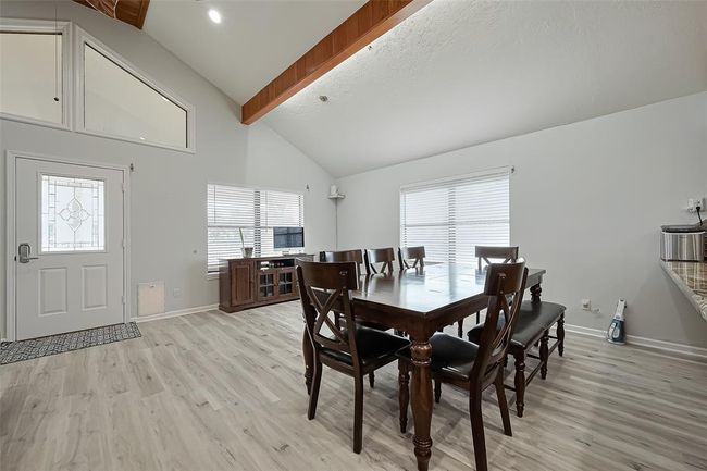 Open dining area with large windows, allowing plenty of natural light. | Image 9