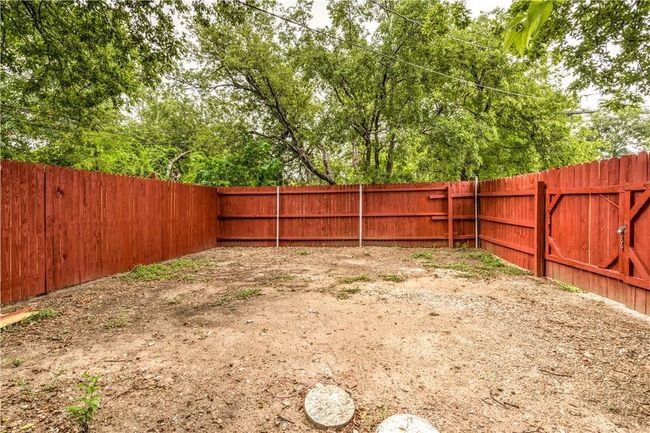View of fenced backyard | Image 13