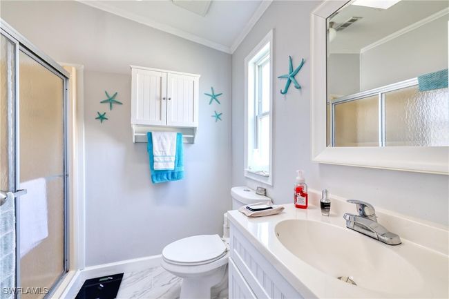 Bathroom with lofted ceiling, toilet, an enclosed shower, and ornamental molding | Image 16