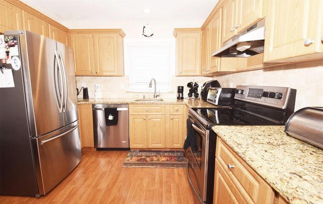 Kitchen under cabinet range hood, granite counters, stainless steel appliances | Image 6