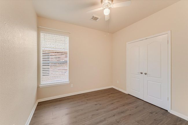 Unfurnished bedroom featuring wood finished floors, a closet, and ceiling fan | Image 18