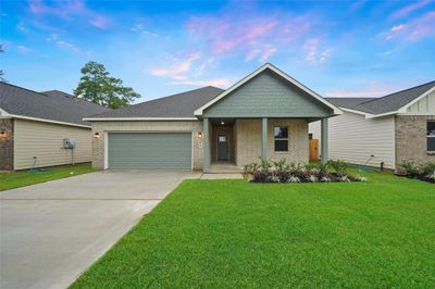 Notice the front landscaping with river rock, sizable covered front porch, and fully sodded front yard. | Image 1