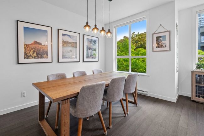Dining room featuring a baseboard radiator, healthy amount of natural light, dark wood-style floors, and baseboards | Image 16