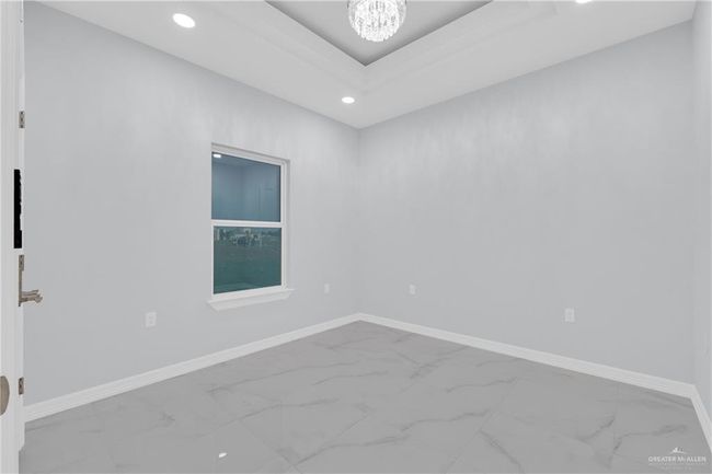 Spare room with marble finish floor, baseboards, a notable chandelier, and recessed lighting | Image 21