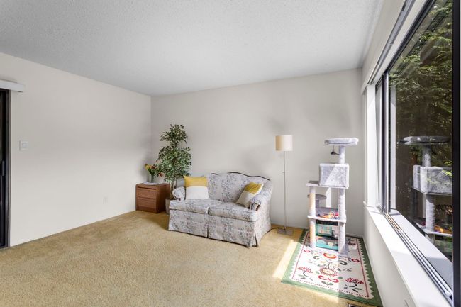 Living area featuring carpet flooring and a textured ceiling | Image 6
