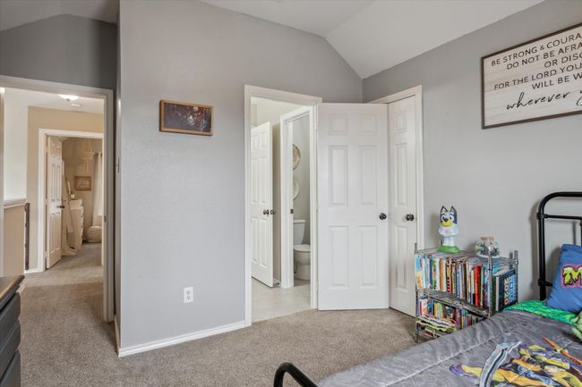 Bedroom featuring carpet flooring, vaulted ceiling, and baseboards | Image 21